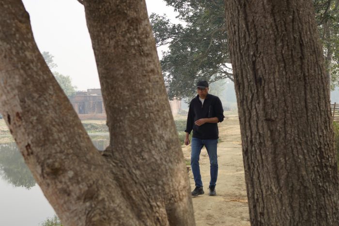 Professor Sanjay Jha deep in thought on the set of Abhivyakti.