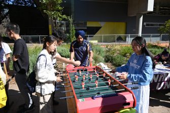 Students playing foosball at UNSW