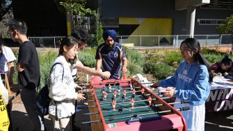 Students playing foosball at UNSW