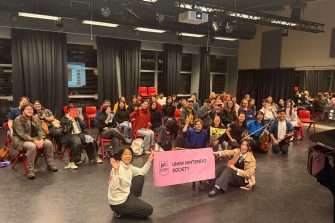 UNSW Nintendo Society members posing in front of their Arc sign and enjoying themselves