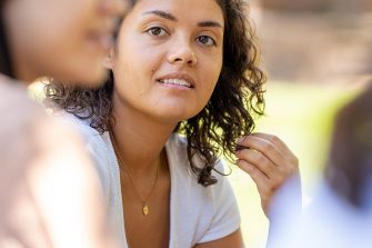 A group of students chatting while sitting on Library Lawn on Kensington Campus