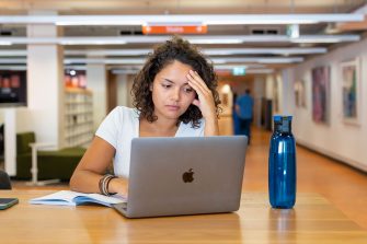 A UNSW student studying at a desk in the library