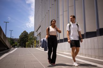 Two students chatting while walking on UNSW Kensington Campus