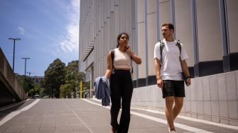 Two students chatting while walking on UNSW Kensington Campus