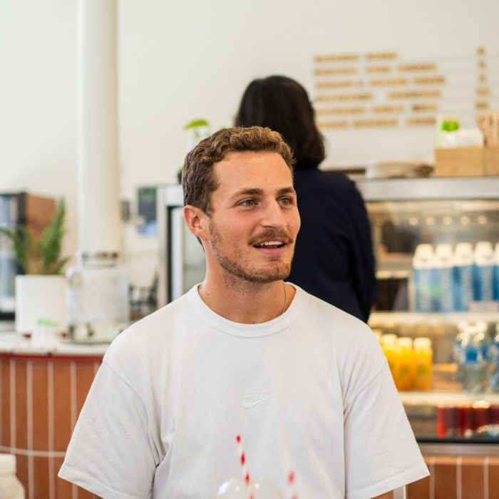 A group of students chatting while sitting at a table at Homeground cafe on UNSW Kensington Campus
