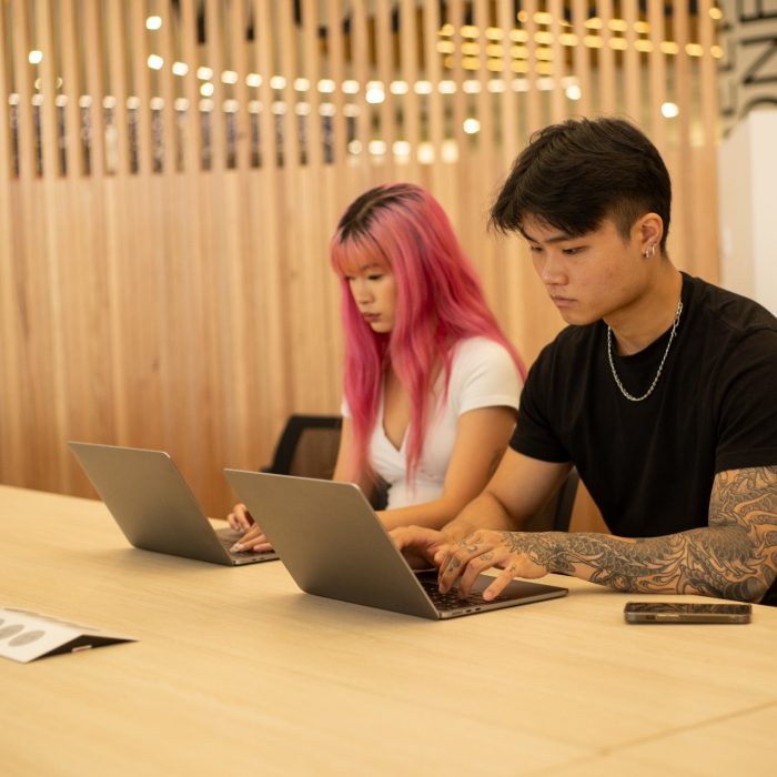 Students with their laptops in the Paddington Library