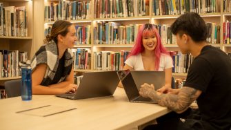 Students with their laptops in the Paddington Library