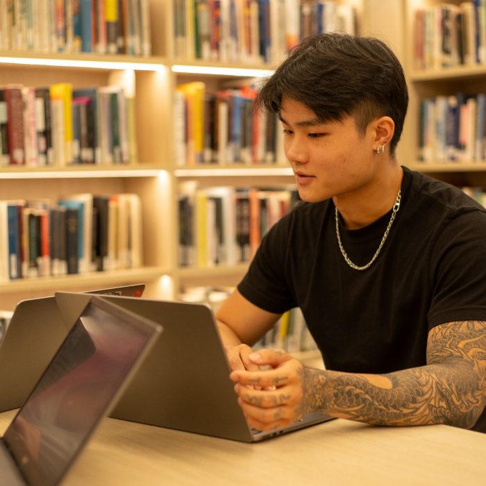 Students with their laptops in the Paddington Library