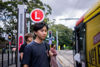 A student at the UNSW HIgh Street light rail stop