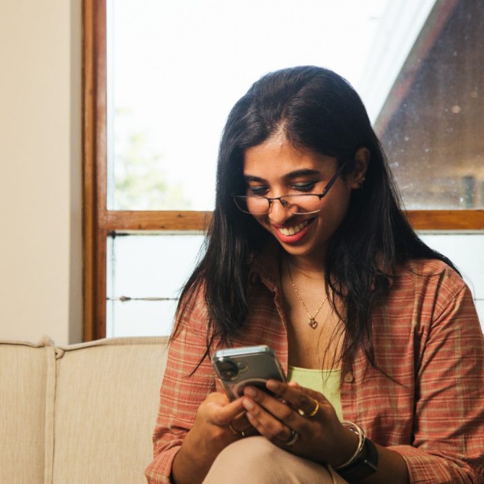 Student looking at their phone indoors on campus