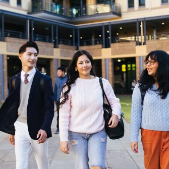 Students walking across Helen Maguire Lawn on campus