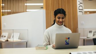 Student at a desk using a laptop