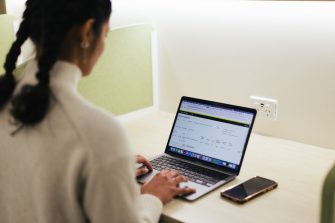 Student at a desk using their laptop to enrol on myUNSW