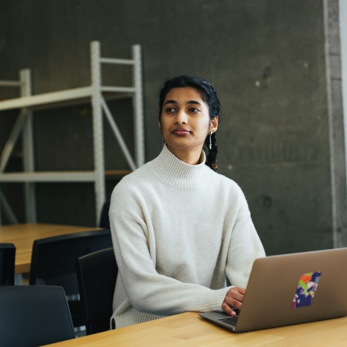 Photo of a student on their laptop in class