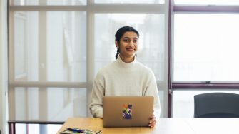 Photo of a student on their laptop in class