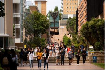 A group of people walk down the stairs on UNSW Campus