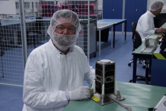 alt="Dr Barnaby Osborne at VKI Headquarters in Delft, Netherlands, undertaking final integration of the UNSW EC0 satellite into the delivery module