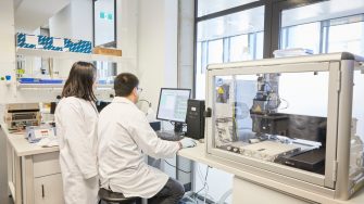 Researchers in laboratory using 3D printer