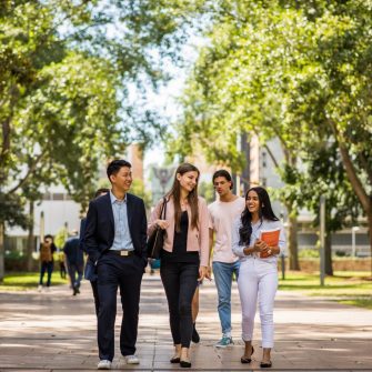 four students walking through the UNSW Kensington campus