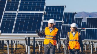 Two Engineers walking through Solar Energy Farm