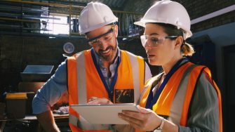 Two engineers looking at checklist