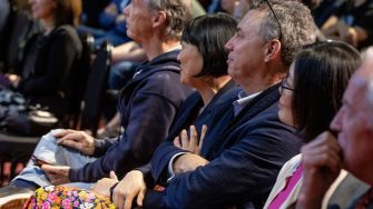 Attendes at event watching presentation