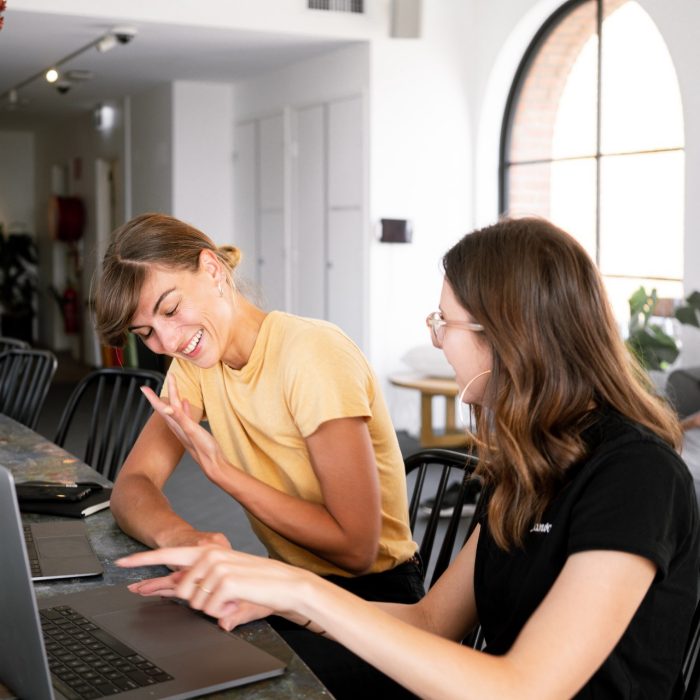 Two women collaborating on a laptop