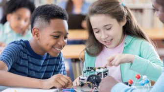 primary school stundents working with a robot