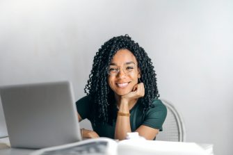 Woman smiling in front of laptop