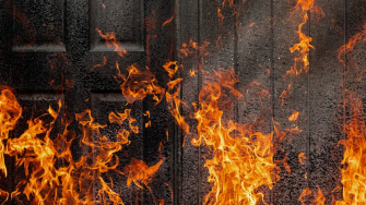 fire in front of black doors