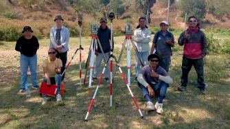 A field survey team poses outdoors with surveying and scanning equipment during research work in Timor-Leste