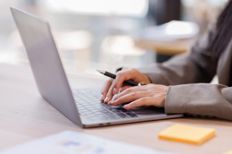 Fast checklist and clipboard task management.Business working on laptop computer productivity checklist and filling survey form online Document management concept 