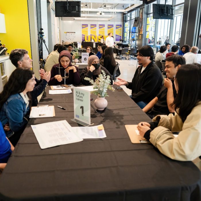 Participants seated around table one sharing ideas at the UNSW–UTS TDS Student Forum.