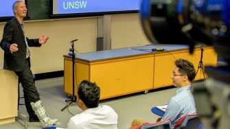 Photo of Stuart Wenham delivering a lecture to students