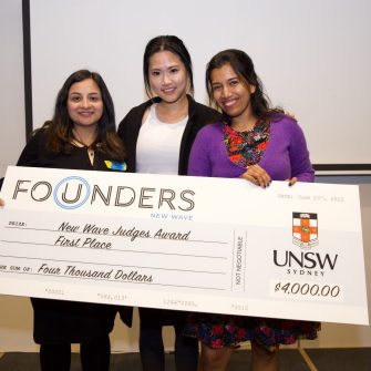 Girls holding the Founders awards card