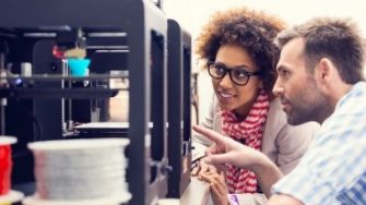 Male and female student looking at 3d printer