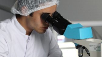 Engineer or scientist looking in microscope 2