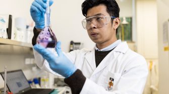 Student inspecting chemical in lab