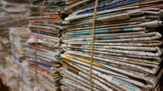 Piles of newspapers bound with string