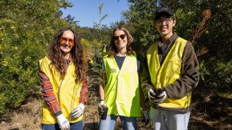 UNSW staff volunteers planting native trees with Greenfleet at Lucas Heights Conservation Area to help restore the endangered Sydney Turpentine Ironbark Forest.