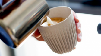 Coffee being poured into a reusable Huskee cup