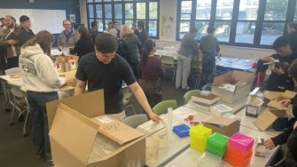 Staff and students sorting and claiming donated lab consumables and equipment at the UNSW TechNet lab swap event.