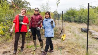 Melissa Nouel, Andrea Aquino and Jordan Vink with a team of Sydney volunteers planting native trees at Lucas Heights Reserve