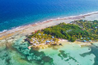 Aerial view of tropical island at Glover's Reef Atoll in Belize Barrier Reef