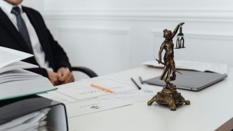 Man at desk with paper weight