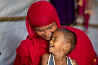 Rohingya refugee Hamida, 26, a mother of four, received a cylinder of liquefied petroleum gas distributed by UNHCR in Kutupalong camp, Cox’s Bazar, Bangladesh. She arrived in Bangladesh three years ago from Myanmar and previously used firewood for cooking. ; From 2018, UNHCR began distributing liquefied petroleum gas to refugees and, more recently, to vulnerable Bangladeshi host communities. Other projects include a biodiversity park, seedling and tree plantations, silt traps to improve water quality, and vertical and rooftop gardening. Solar energy is being expanded throughout the camps, with solar-powered street lighting and solar mini grids powering facilities such as health and community centres.