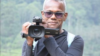 Visakesa Chandrasekaram holding camera recording
