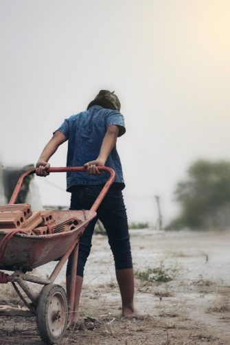 Child labor in building commercial building structures. World Labor Day concept