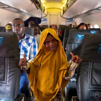Somali refugees board a flight from Dadaab to be resettled in Sweden. ; The Dadaab refugee complex has a population of over 200,000 registered refugees and asylum-seekers and consists of four camps – Dagahaley, Ifo, Ifo 2 and Hagadera. The first camp was established in 1991, when refugees fleeing the civil war in Somalia started to cross the border into Kenya. A second large influx occurred in 2011, when some 130,000 refugees arrived, fleeing drought and famine in southern Somalia. There is a considerable difference between the old camps – which have developed into commercial hubs and house refugees who arrived in the 1990s, as well as their children and grandchildren – and the new camp, Ifo 2, which is mostly home to pastoralists who arrived in 2011.