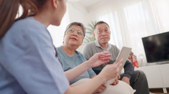Professionals Asian female doctors consultations for the elderly couple, presentations check-up health, or share test results using a digital tablet, and discuss their health concerns of them. Concepts of health care, health insurance, retirement.